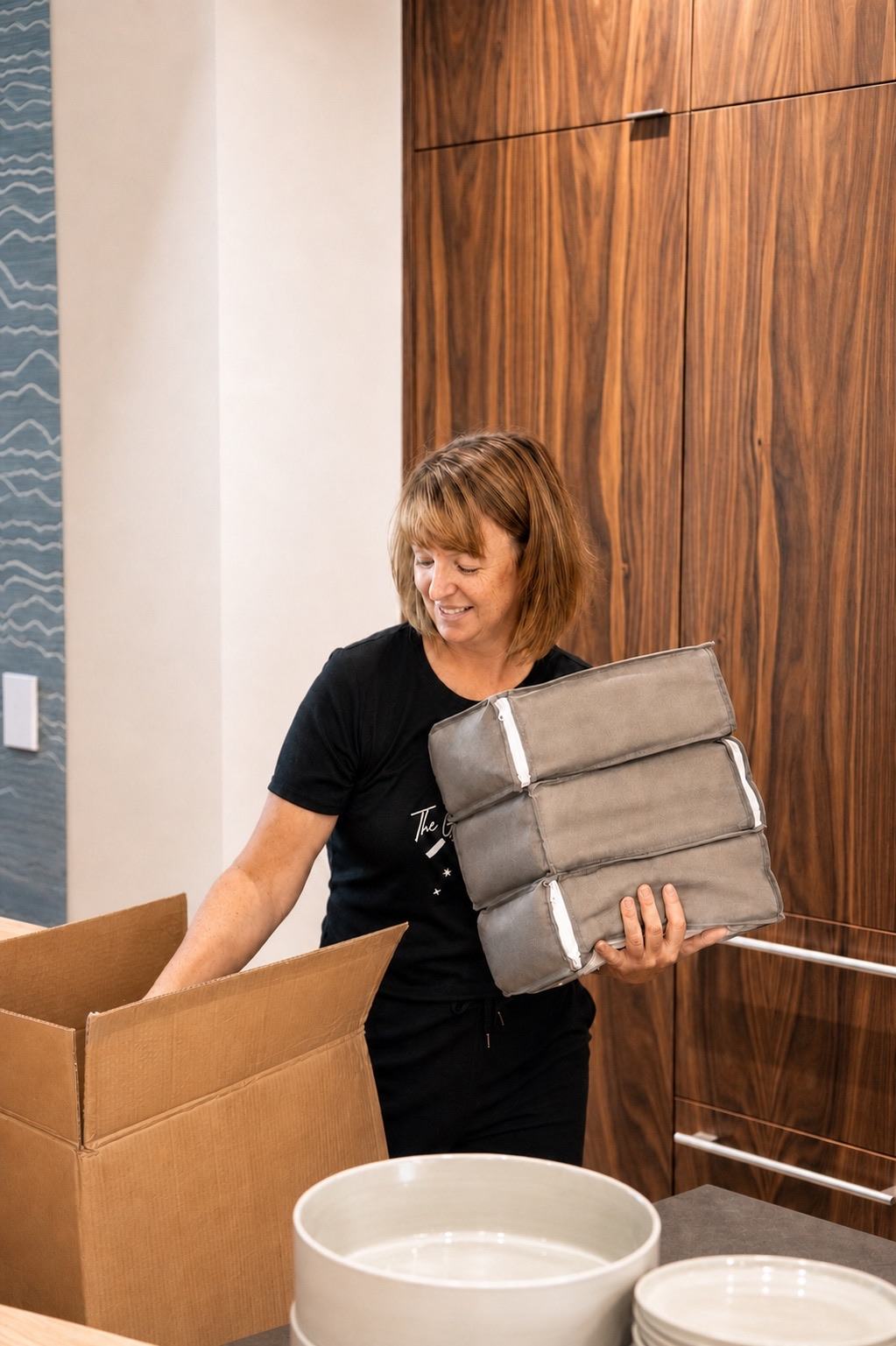 Claudia unpacking a delivery in a client home